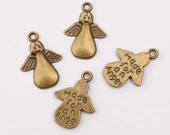 May include: Four antique gold angel charms. Two charms feature a small angel with wings and a smiling face. Two charms are shaped like angels with the words "Made for an Angel" inscribed on them.