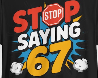 May include: Black t-shirt with a colorful graphic that reads "STOP SAYING 67". The text is in red, white, and yellow, with a stop sign icon. The design has a comic book style with blue and white accents.