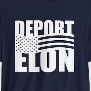 May include: A navy blue t-shirt featuring the white text "DEPORT ELON". The design includes a graphic of the American flag. The t-shirt has a crew neck and short sleeves, a common style in the UK.