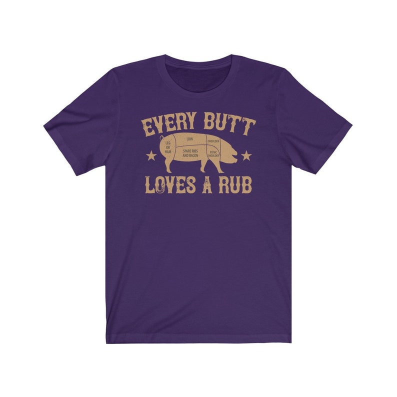 May include: Purple short-sleeved t-shirt with a brown graphic of a pig with a butcher diagram and the text "Every Butt Loves A Rub".