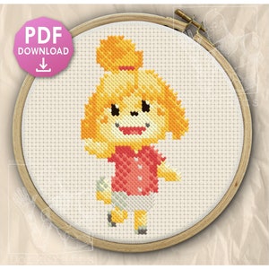 May include: A cross-stitch pattern featuring a yellow dog character with a high ponytail, wearing a red shirt and white skirt, displayed in a wooden embroidery hoop. A pink circular icon with the text PDF DOWNLOAD is in the top left corner.