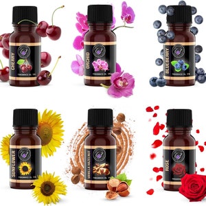 May include: Six small brown glass bottles with gold labels and black caps. Each bottle contains essential oil and has a different scent: Cherry, Orchid, Blueberry, Sunflower, Vanilla Hazelnut, and Rose. The bottles are arranged in two rows of three.
