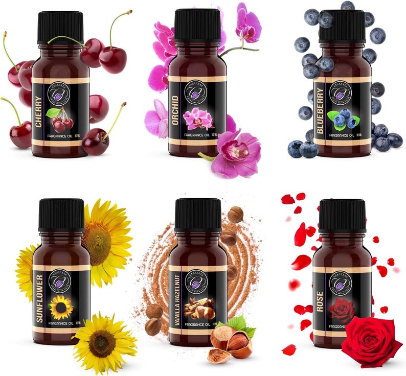 May include: Six small brown glass bottles with gold labels and black caps. Each bottle contains essential oil and has a different scent: Cherry, Orchid, Blueberry, Sunflower, Vanilla Hazelnut, and Rose. The bottles are arranged in two rows of three.