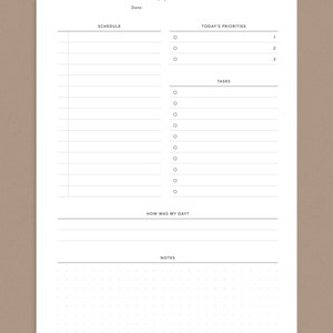 May include: A white daily planner with a black header that says "daily planner." The planner has sections for schedule, today's priorities, tasks, how was my day, and notes.