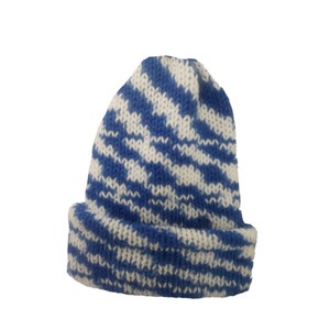 May include: Blue and white striped knitted beanie hat. The hat is made of a soft, warm material and has a classic design.