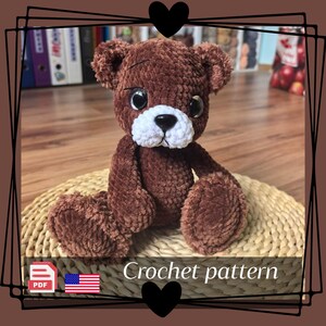 May include: A handmade brown crochet teddy bear with a white muzzle and large black eyes. The bear is sitting on a woven mat. The image includes the text "Crochet pattern" and a PDF icon.
