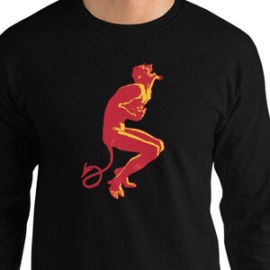 May include: A black long-sleeve t-shirt with a red and yellow silhouette of a devil figure with a tail.