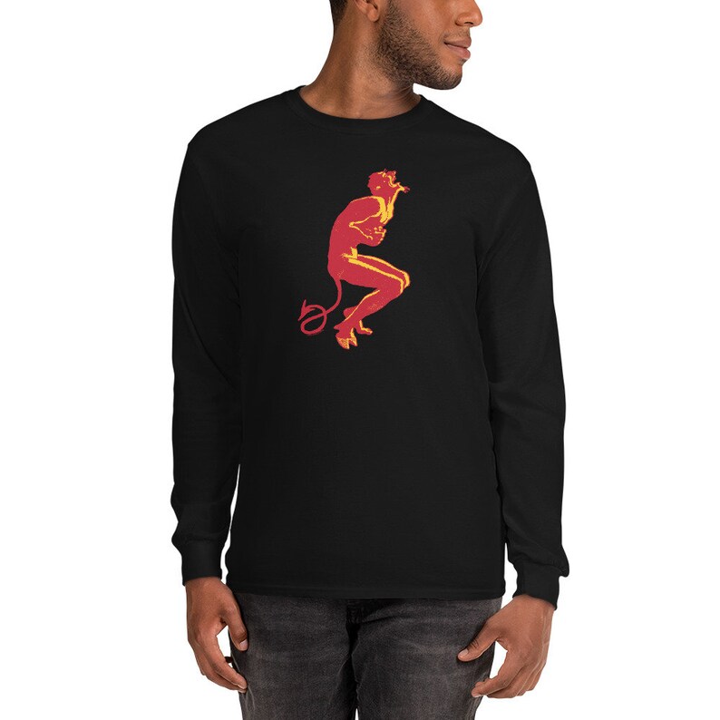 May include: A black long-sleeve t-shirt with a red and yellow silhouette of a devil figure with a tail.