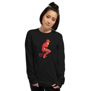 May include: A black long-sleeve shirt with a red and yellow silhouette of a devil figure with a tail.
