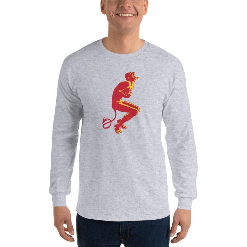 May include: A gray long-sleeve t-shirt with a red and yellow illustration of a devil figure with a curled tail.