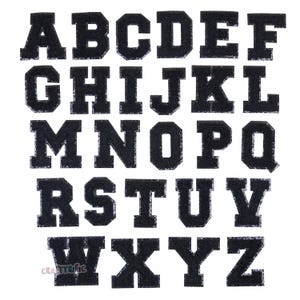 May include: Black felt letter patches in uppercase, A through Z. The letters are in a bold, blocky font style.