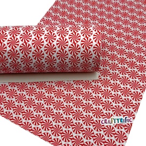 May include: A roll of white material with a repeating pattern of red and white peppermint candies. The material is partially rolled, revealing the pattern on the surface. The CraftyRific logo is visible in the lower right corner.