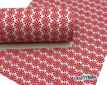 May include: A roll of white material with a repeating pattern of red and white peppermint candies. The material is partially rolled, revealing the pattern on the surface. The CraftyRific logo is visible in the lower right corner.