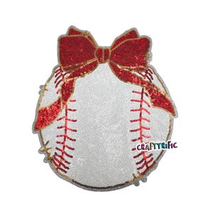 May include: A baseball-themed sequin applique with a red sequin bow at the top. The baseball is white with red stitching and a gold border. The text "CraftyRific" is visible on the right side.