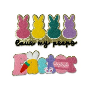 May include: A colorful felt Easter patch with the text "Leave my peeps" and a row of four pastel-colored bunny shapes. Below the text is a second patch with the word "Easter" in colorful felt letters with a bunny, carrot, and egg design.
