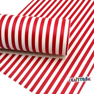 May include: Red and white striped fabric with a textured surface. The fabric is rolled up and the end of the roll is visible. The fabric is labeled "CRAFTYRiFic".