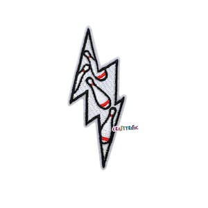 May include: Embroidered patch in the shape of a white lightning bolt with a black outline. The lightning bolt design features white bowling pins with red accents. The text "CraftyRific" is in the lower right corner.
