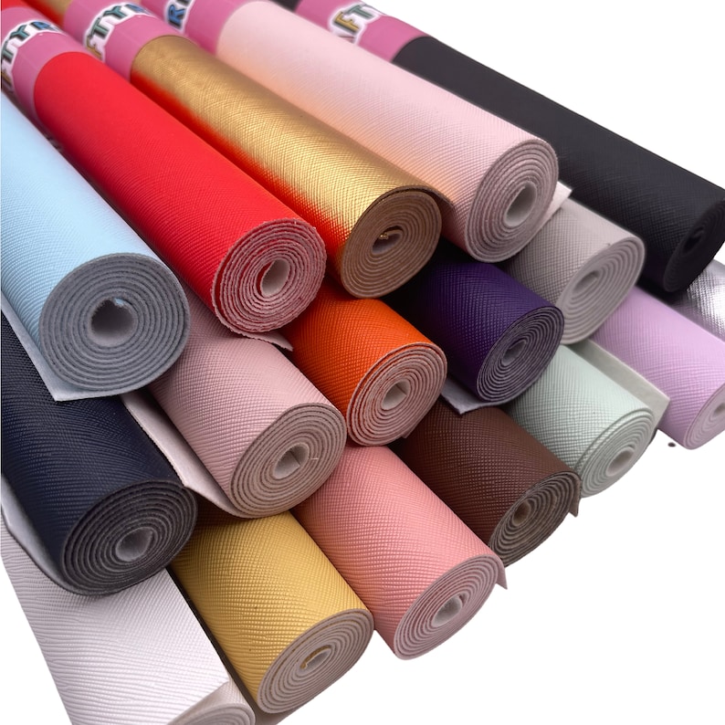 May include: A collection of rolled faux leather sheets in various colors, including red, gold, and black. The rolls are arranged diagonally, showcasing the textured surface and the variety of shades available for crafting projects.