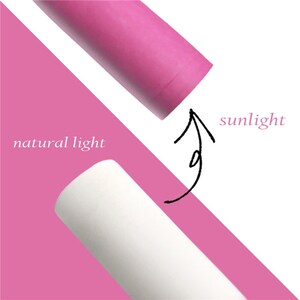 May include: A comparison of natural light and sunlight. A white cylinder is labeled "natural light" and a pink cylinder is labeled "sunlight". An arrow points from the pink cylinder to the white cylinder.