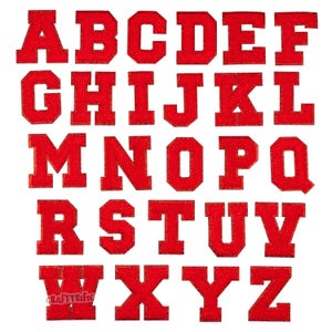 May include: Red felt alphabet letters in a block font style. The letters are arranged in alphabetical order in three rows.