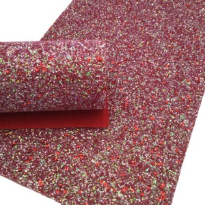 May include: Red glitter fabric with iridescent sequins. The fabric has a fine, sparkly texture.