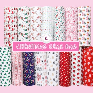 May include: A Christmas grab bag featuring 12 different patterned fabric rolls. The patterns include Christmas trees, reindeer, elves, snowflakes, and more. The fabric rolls are all white with red, green, and blue accents.