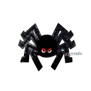 May include: A black spider decoration with glitter accents on the legs and body. The spider has red eyes and a stern expression. The image includes the text "CraftyRific".