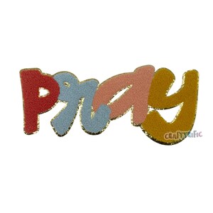 May include: A colorful patch with the word "PRAY" in a playful, textured font. The letters are red, light blue, peach, and mustard yellow, outlined with gold glitter. The patch has a white background and the text "CRAFTYrific" in the bottom right corner.