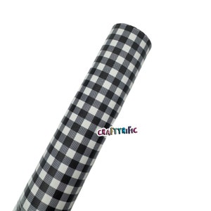 May include: A roll of black and white gingham patterned material. The material is rolled up, displaying the repeating checkered pattern. The text "CRAFTYRIFIC" is visible on the roll.