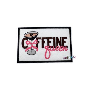 May include: Embroidered iron-on patch with a black border and white background. The patch features a martini glass with a pink bow and the text "CAFFEINE queen" in brown and pink lettering.