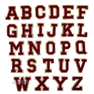 May include: A set of 26 burgundy felt letters with gold trim, each letter is approximately 2 inches tall. The letters are arranged in alphabetical order.