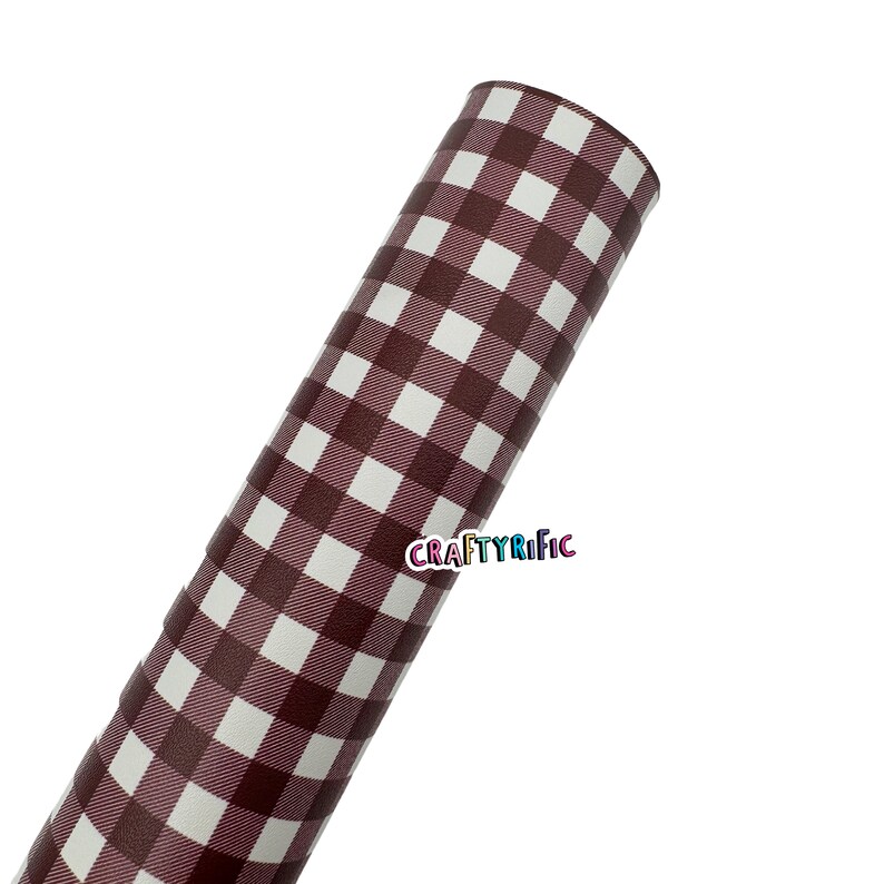 May include: Rolled sheet of material with a brown and white gingham pattern. The material is tightly rolled, displaying the repeating square pattern. The text "CRAFTYRIFIC" is visible in the lower right corner.