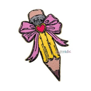 May include: A yellow pencil with a pink bow and a red heart. The pencil is embroidered with a fuzzy texture.