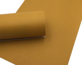 May include: A sheet of mustard yellow faux leather with a textured finish. The leather is rolled up and the texture is visible.