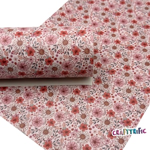 May include: Pink faux leather with a floral print featuring red, white, and brown flowers. The print is a repeating pattern of various sized flowers.