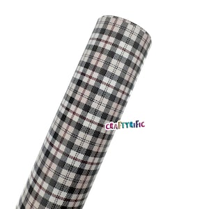 May include: Rolled sheet of material with a black, white, and burgundy plaid pattern. The material has a repeating grid design. The word "CRAFTYRIFIC" is printed in a colorful font on the lower right side of the image.