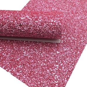 May include: Pink glitter fabric with a fine, even texture. The glitter is densely packed, creating a shimmering effect.