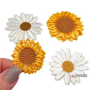 May include: Four embroidered iron-on patches featuring two white daisies and two yellow sunflowers. The patches are perfect for adding a touch of whimsy to clothing, bags, or other fabric items.