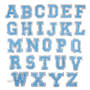 May include: A set of 26 blue felt letter patches with a silver outline. The letters are in uppercase and are arranged in alphabetical order.