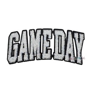 May include: A sequined patch in a curved shape, featuring the word "GAMEDAY" in large, block letters. The letters are filled with silver sequins and outlined in black. The patch is designed for apparel or accessories.