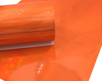 May include: A roll of bright orange faux leather with a glossy finish. The leather is rolled up and the end is visible.