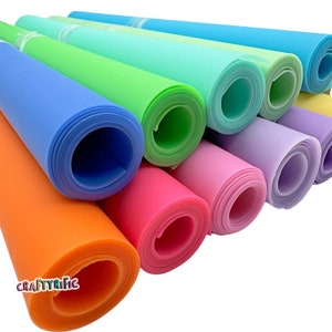 May include: A set of ten colorful rolls of silicone craft sheets. The sheets are rolled up and stacked on top of each other. The colors are orange, pink, lavender, light blue, green, and light blue.