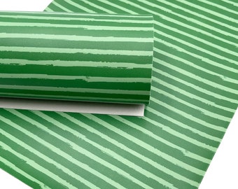 May include: Green and white striped fabric with a brushstroke pattern. The fabric is rolled up and the stripes are horizontal.