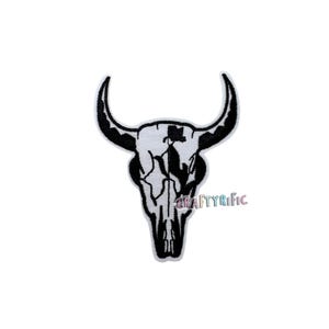 May include: Embroidered patch featuring a black and white bull skull design. The skull has detailed shading and curved horns. The patch is likely for clothing or accessories.