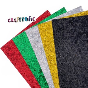 May include: Six sheets of sparkly, iridescent sequin fabric in red, green, silver, gold, and black. The fabric is arranged in a fan shape.