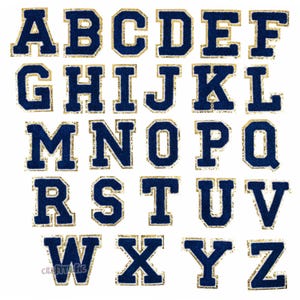May include: A set of 26 uppercase letters in a navy blue felt with a gold glitter outline. The letters are in a classic block font style.