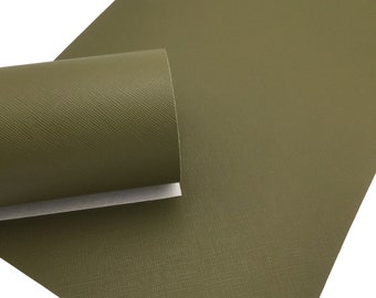 May include: A sheet of green faux leather with a textured, pebbled surface. The leather is rolled up, showing the texture.