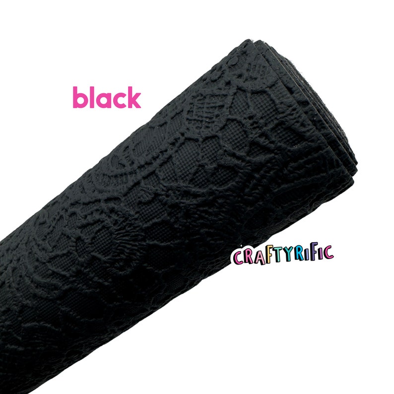 May include: Black lace fabric with a textured pattern. The fabric is rolled up and the word "black" is written in pink letters above the fabric.