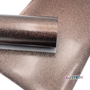 May include: A roll of brown glitter faux leather with a shiny finish. The material is textured with fine glitter particles.