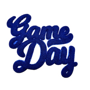 May include: Blue felt "Game Day" sign with a cursive font.
